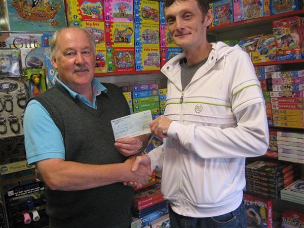 Paul Devine receives his cheque for £1500 from Forfar Athletic Director, Dennis Fenton.. 20120813lotterywinner2