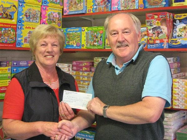 Kathleen McDonald receives her cheque for £1500 from Forfar Athletic Director, Dennis Fenton.. 20120813lotterywinner2