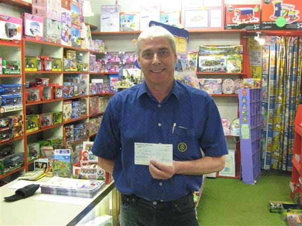 Kathleen McDonald receives her cheque for £1500 from Forfar Athletic Director, Dennis Fenton.. 20120903lotterywinners